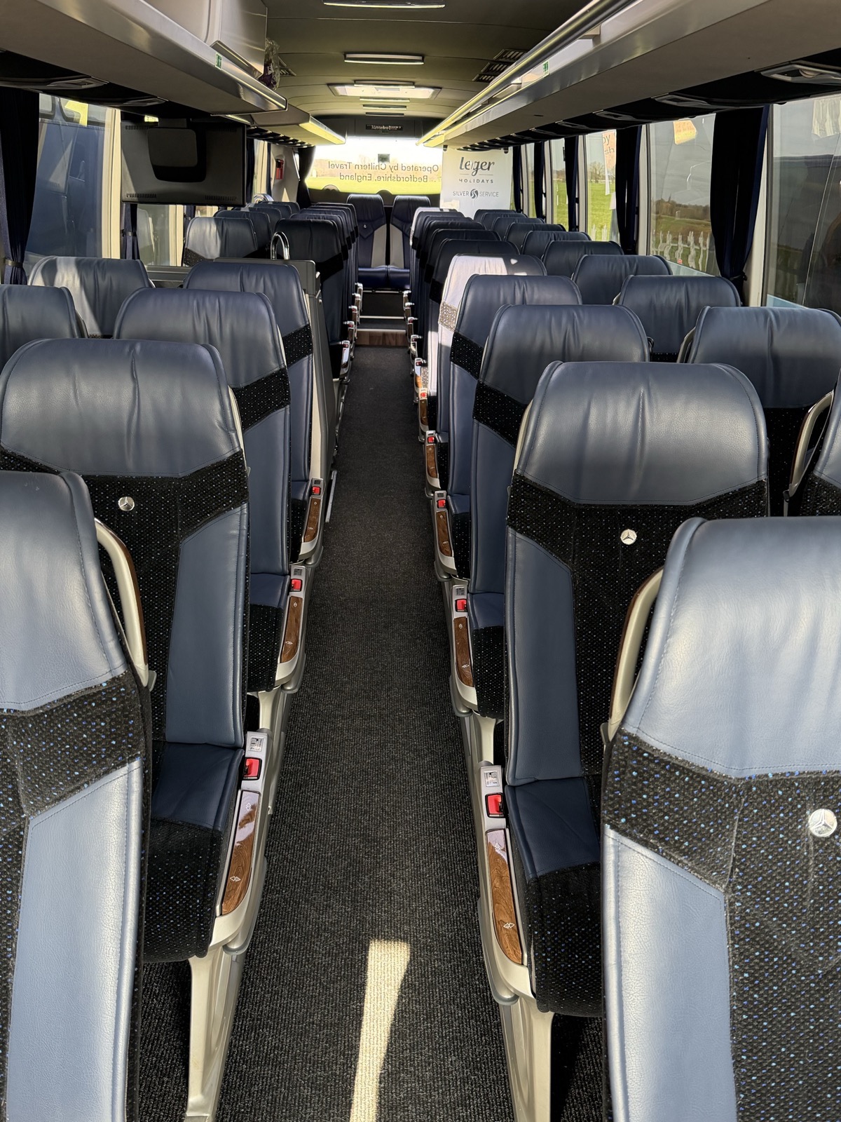 Coach aisle with leather seating and wood trim